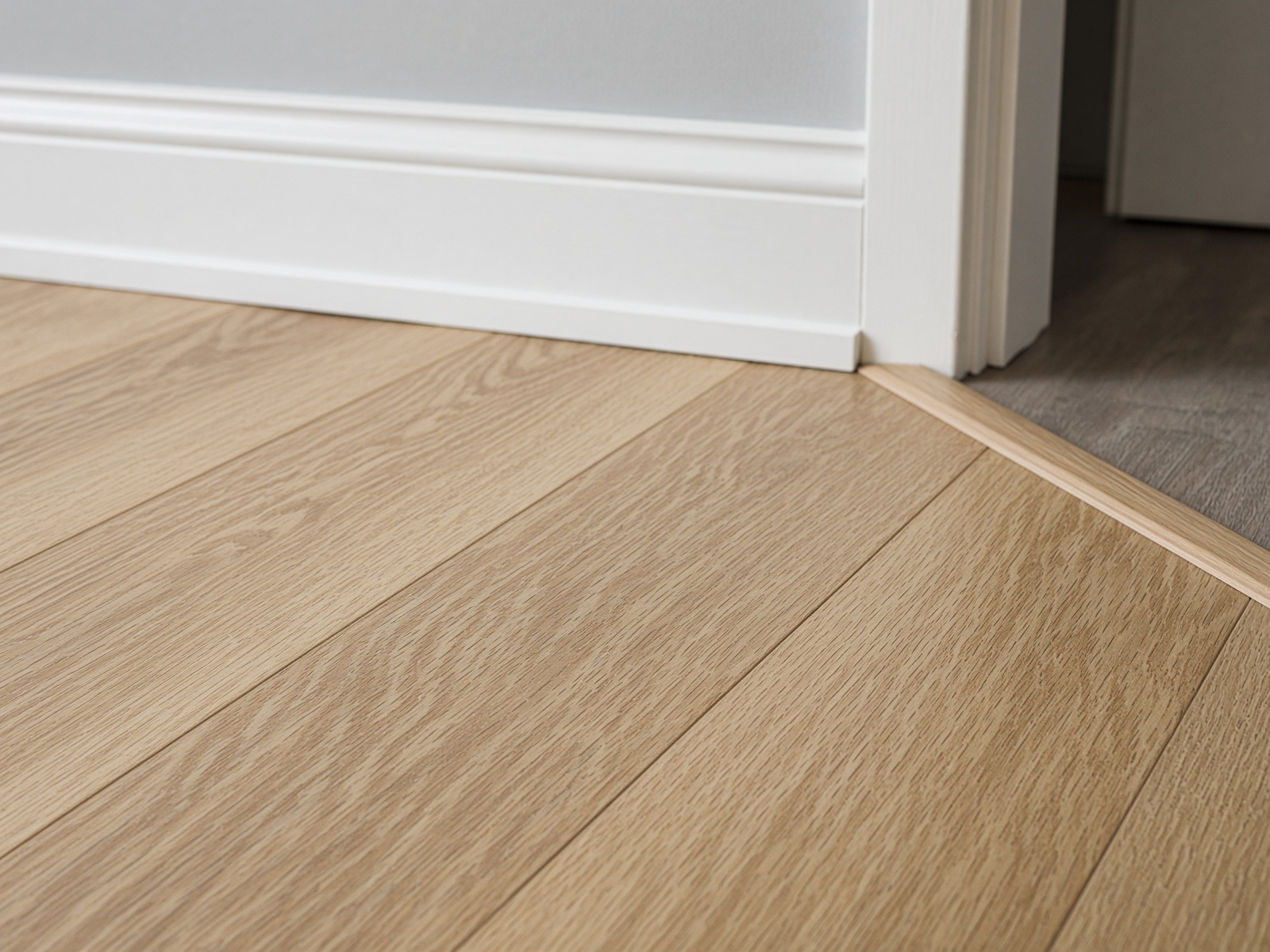 Oak-look luxury vinyl plank meeting trim at Bryson Co LLC, Gadsden AL